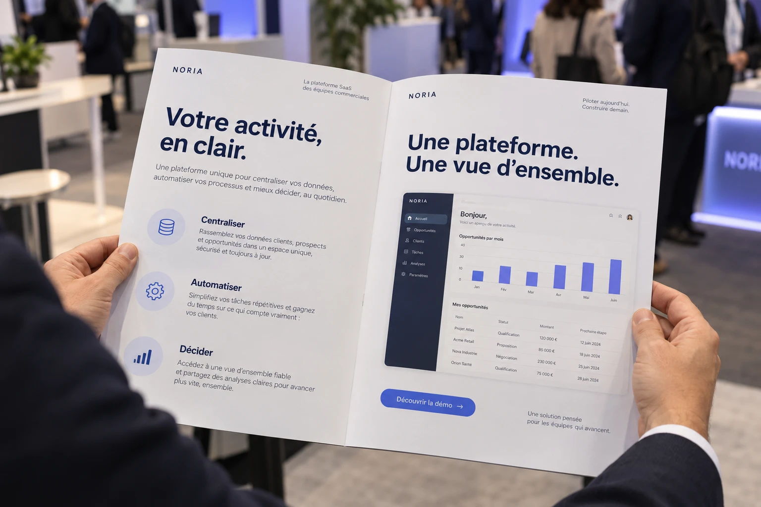 Open brochure for the fictional SaaS brand Noria, held at a B2B trade show, showing product benefits and an interface preview
